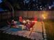 A cozy backyard patio featuring comfortable seating around a fire pit, ideal for outdoor entertaining at 3209 S Dorchester Dr, Deltona, FL 32738