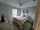 Cozy bedroom with a comfortable bed, neutral walls, and a ceiling fan at 3209 S Dorchester Dr, Deltona, FL 32738