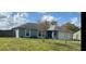 Cozy single-story home with a well-manicured lawn and attached two-car garage at 3209 S Dorchester Dr, Deltona, FL 32738