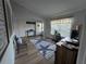 Bright living room with a large window, wood floors, and stylish decor at 3209 S Dorchester Dr, Deltona, FL 32738
