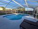 Sparkling enclosed pool with lounge chairs and a clear enclosure providing a perfect oasis at 3209 S Dorchester Dr, Deltona, FL 32738