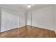 Bedroom features a ceiling fan, hardwood floors, and double-door closet at 369 Caddie Dr, Debary, FL 32713