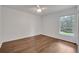 Neutral bedroom features a ceiling fan, window, and hardwood floors at 369 Caddie Dr, Debary, FL 32713