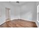 Clean and simple bedroom with hardwood floors, white walls, and a ceiling fan, offering a serene atmosphere at 369 Caddie Dr, Debary, FL 32713