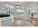 Bright breakfast nook with chandelier and sliding doors overlooking the pool and lush backyard at 369 Caddie Dr, Debary, FL 32713