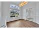 Dining room featuring hardwood floors, a large window and front door at 369 Caddie Dr, Debary, FL 32713