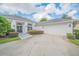 Exterior of a house featuring a garage, landscaped yard, and a walkway leading to the front door at 369 Caddie Dr, Debary, FL 32713