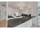 Spacious kitchen with modern appliances and expansive black countertops with eat-in bar at 369 Caddie Dr, Debary, FL 32713