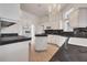 Spacious kitchen with white cabinets, black countertops and modern appliances at 369 Caddie Dr, Debary, FL 32713