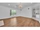 Open living room with hardwood floors, large windows and a chandelier at 369 Caddie Dr, Debary, FL 32713