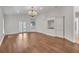 Light-filled living room with hardwood floors, built-in shelving, and french doors, illuminated by a chandelier at 369 Caddie Dr, Debary, FL 32713
