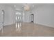 Bright living room with tiled floors and a crystal chandelier at 369 Caddie Dr, Debary, FL 32713