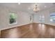 Spacious living room featuring hardwood floors, elegant lighting, and backyard access through double doors at 369 Caddie Dr, Debary, FL 32713