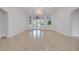 Bright living room with neutral tile flooring, transom windows, and french doors offering a view of the pool area at 369 Caddie Dr, Debary, FL 32713