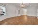 Open living room featuring hardwood floors, built-in cabinetry, and a chandelier, with view to bathroom in the distance at 369 Caddie Dr, Debary, FL 32713