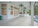 A full outdoor bar with ceiling fans, looking out to the screened-in pool area at 369 Caddie Dr, Debary, FL 32713