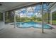 View of pool with golf course, screened in lanai, and outdoor kitchen at 369 Caddie Dr, Debary, FL 32713