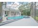 Pool area with outdoor kitchen and screened in lanai at 369 Caddie Dr, Debary, FL 32713