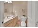 Bright bathroom featuring a single vanity, a toilet, and decorative accents throughout the space at 37 Fairway Ct # C, Deland, FL 32724