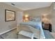 Serene bedroom with a white bed frame, blue floral bedding, and a classic wooden dresser at 37 Fairway Ct # C, Deland, FL 32724