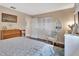 Relaxing bedroom with closet, chair, dresser, and a comfortable bed with blue and white bedding at 37 Fairway Ct # C, Deland, FL 32724