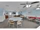 Spacious common room featuring tables, chairs, ceiling fans, and ample natural light at 37 Fairway Ct # C, Deland, FL 32724
