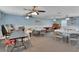 A spacious room with tables, chairs, ceiling fans, and a neutral color scheme offers a flexible space for gatherings at 37 Fairway Ct # C, Deland, FL 32724