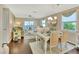Bright dining area featuring a white table set for four with coastal decor and hardwood floors at 37 Fairway Ct # C, Deland, FL 32724
