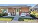 Welcoming front porch with white wicker furniture, perfect for enjoying the outdoors at 37 Fairway Ct # C, Deland, FL 32724