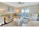 Inviting living room with plush seating, stylish decor, and access to a screened lanai at 37 Fairway Ct # C, Deland, FL 32724