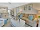 Open-concept living area with dining room and kitchen views, featuring hardwood floors and neutral decor at 37 Fairway Ct # C, Deland, FL 32724