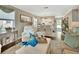 Comfortable living area with stylish furniture, hardwood floors, and open layout to the dining area at 37 Fairway Ct # C, Deland, FL 32724