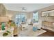 Cozy living room with a ceiling fan, comfortable seating, and sliding glass doors to the lanai at 37 Fairway Ct # C, Deland, FL 32724