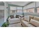 Cozy sun room featuring neutral couches, multiple windows, and a refreshing mint green wall at 37 Fairway Ct # C, Deland, FL 32724