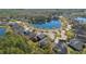Aerial view of homes surrounding a cul-de-sac with a lake featuring well-maintained landscaping at 376 Chelsea Place Ave, Ormond Beach, FL 32174