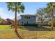 Backyard view showcasing a two-story home with a screened lanai and lush landscaping at 376 Chelsea Place Ave, Ormond Beach, FL 32174
