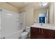 Bathroom showing the vanity, mirror, toilet, and shower with white tile at 376 Chelsea Place Ave, Ormond Beach, FL 32174
