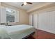 Bedroom showcasing wood floors, bright shutters, and double door closets at 376 Chelsea Place Ave, Ormond Beach, FL 32174