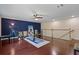 Spacious bonus room features exercise equipment, a yoga mat, and hardwood floors at 376 Chelsea Place Ave, Ormond Beach, FL 32174