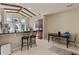 Dining area with a view, includes modern bar stool seating and a dining table at 376 Chelsea Place Ave, Ormond Beach, FL 32174