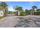 Gated community entrance with stone pillars and intricate ironwork, enhancing security and curb appeal at 376 Chelsea Place Ave, Ormond Beach, FL 32174