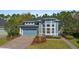 Charming blue two-story home with a two-car garage and professionally landscaped front yard and walkway at 376 Chelsea Place Ave, Ormond Beach, FL 32174