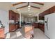 Open-concept kitchen with wooden cabinets, granite counters, stainless appliances, and an island at 376 Chelsea Place Ave, Ormond Beach, FL 32174