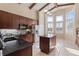 Bright kitchen with dark cabinets, stainless steel appliances and a center island, with lovely natural light at 376 Chelsea Place Ave, Ormond Beach, FL 32174