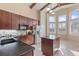 Bright kitchen featuring dark wood cabinets, black countertops, stainless steel appliances, and lots of natural light at 376 Chelsea Place Ave, Ormond Beach, FL 32174