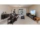 Spacious living room with cozy seating, sliding door access to the porch, and entertainment center at 376 Chelsea Place Ave, Ormond Beach, FL 32174