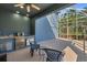 Screened-in outdoor kitchen with a grill, sink, refrigerator, and seating area at 376 Chelsea Place Ave, Ormond Beach, FL 32174