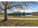 Scenic pond surrounded by lush landscaping offers a serene natural view with a concrete walking path at 376 Chelsea Place Ave, Ormond Beach, FL 32174