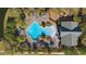 Aerial view of large community swimming pool surrounded by mature landscaping and lounge chairs under sunny skies at 376 Chelsea Place Ave, Ormond Beach, FL 32174