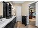 Elegant bathroom with double vanity, black cabinets, white countertop, and tile flooring at 3955 Equine Cv, Lake Mary, FL 32746